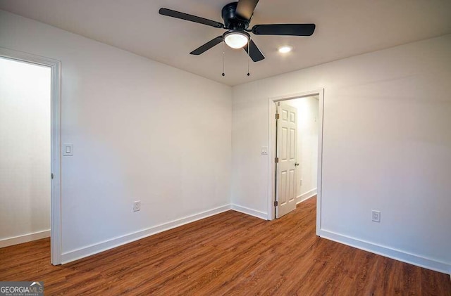 spare room with ceiling fan and wood-type flooring