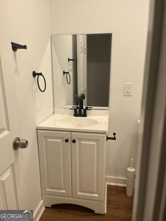 bathroom with vanity and hardwood / wood-style flooring