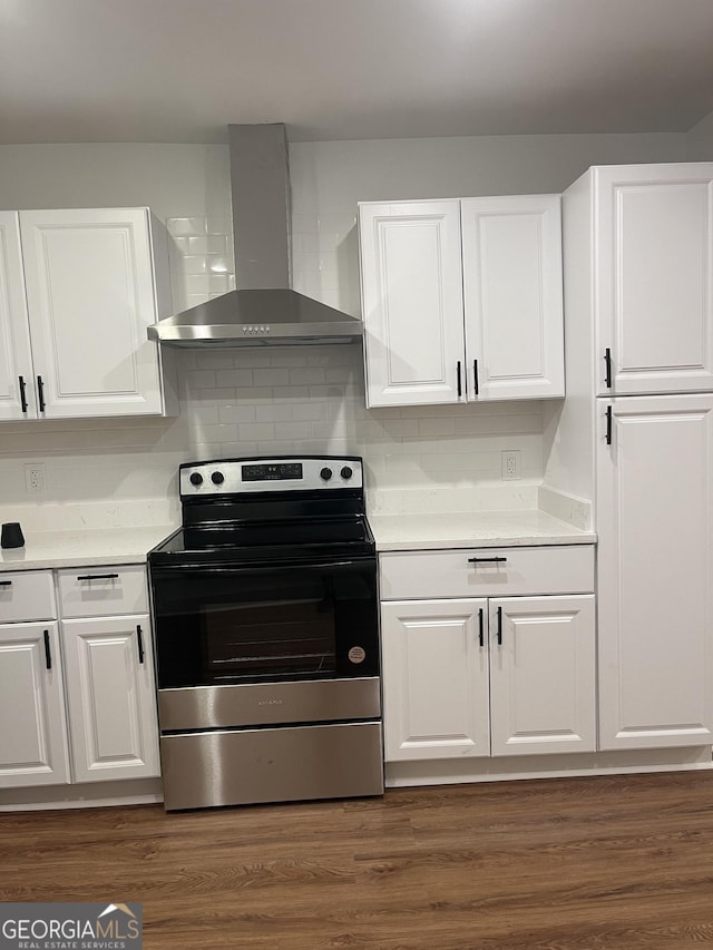 kitchen featuring white cabinetry, stainless steel electric stove, dark wood-type flooring, and wall chimney range hood