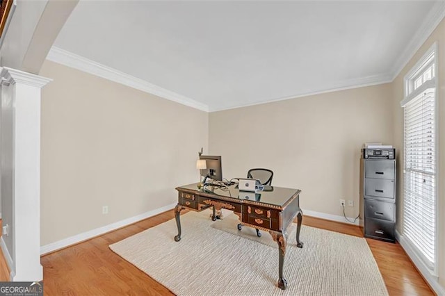 office area featuring baseboards, ornamental molding, and wood finished floors