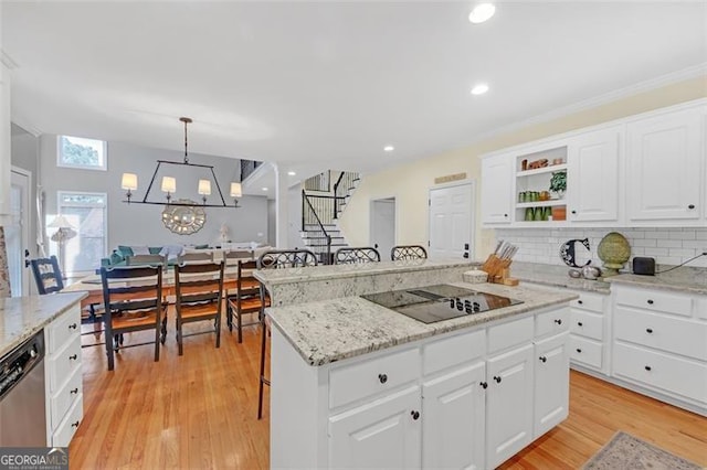 kitchen with dishwasher, a center island, black electric stovetop, light wood-style floors, and open shelves