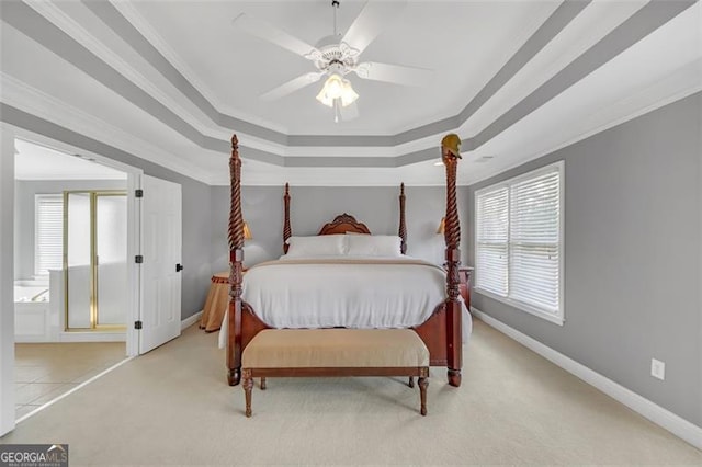 carpeted bedroom with ornamental molding, a raised ceiling, baseboards, and a ceiling fan