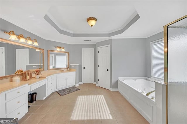 bathroom featuring a healthy amount of sunlight, a tray ceiling, a bath, and tile patterned floors