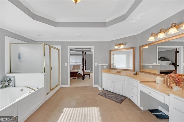 bathroom with a tray ceiling, ensuite bath, and a healthy amount of sunlight