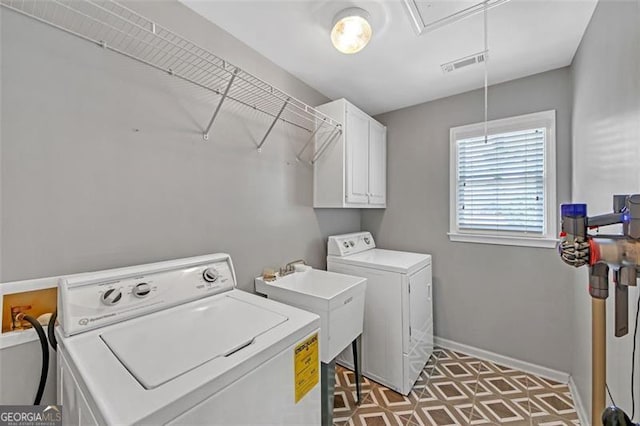 clothes washing area with visible vents, baseboards, independent washer and dryer, cabinet space, and attic access