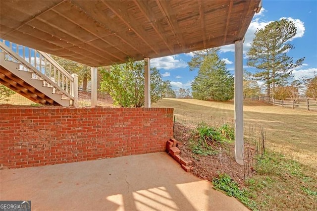 view of patio featuring fence