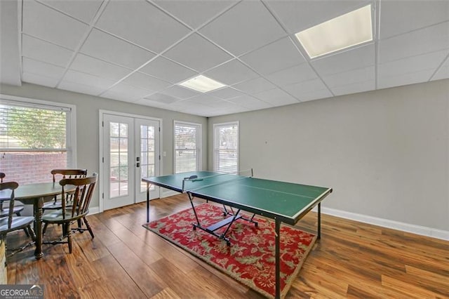 playroom featuring french doors, a paneled ceiling, and hardwood / wood-style flooring