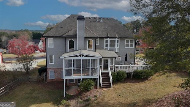 back of house with fence, a sunroom, stairway, a wooden deck, and a chimney