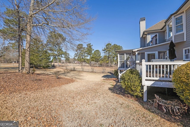 view of yard featuring a sunroom