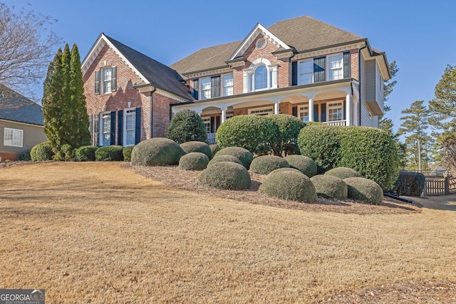 view of front of house with brick siding and a porch