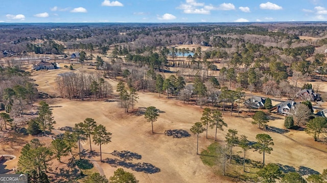 birds eye view of property featuring a view of trees