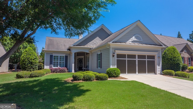 view of front of property featuring a garage and a front lawn