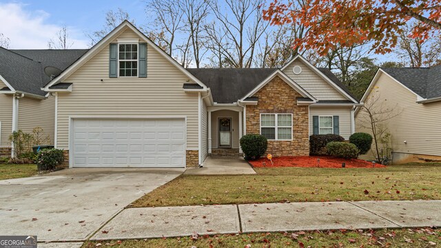 view of front of home with a garage and a front lawn