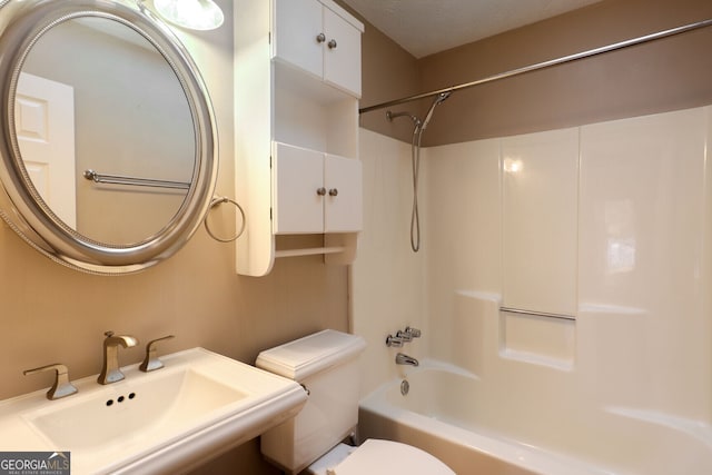 full bathroom with shower / washtub combination, sink, a textured ceiling, and toilet