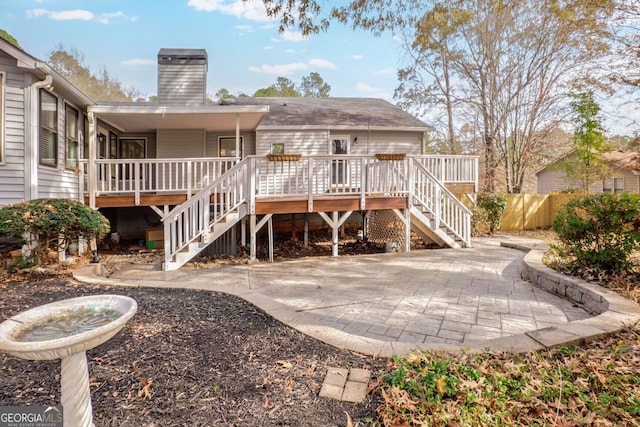 rear view of house with central AC unit and a patio