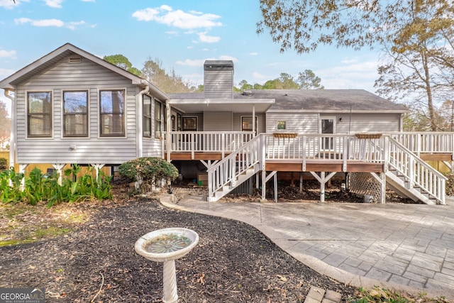 back of house with a wooden deck