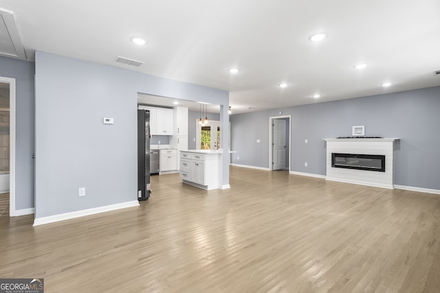 unfurnished living room featuring light hardwood / wood-style flooring