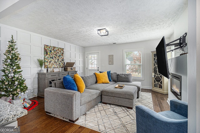 living room featuring a textured ceiling and light wood-type flooring