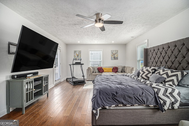 bedroom featuring a textured ceiling, ceiling fan, and dark hardwood / wood-style floors