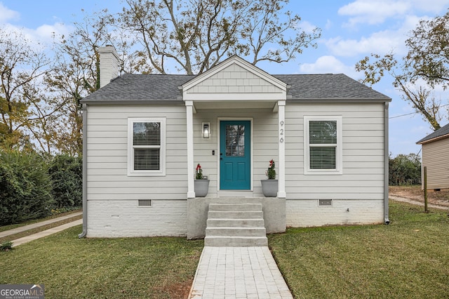 bungalow-style home featuring a front yard