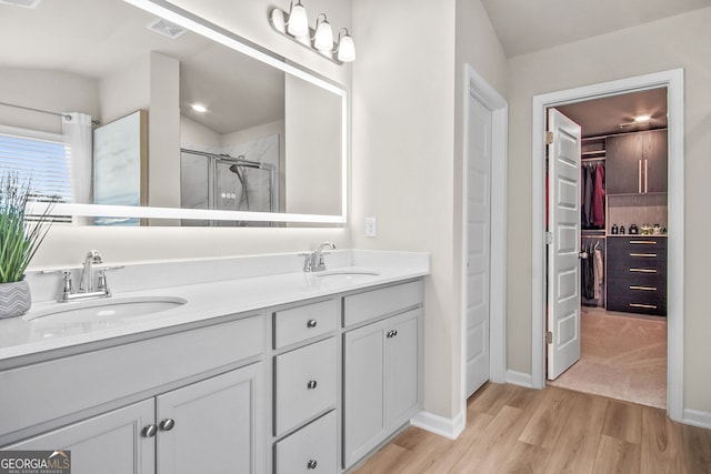 bathroom featuring vanity, a shower with shower door, and hardwood / wood-style flooring