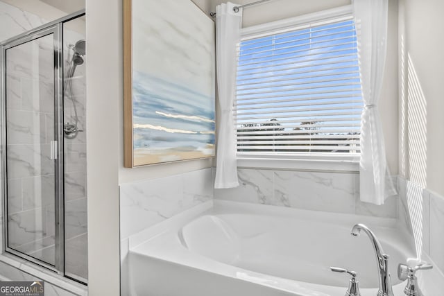 bathroom featuring shower with separate bathtub