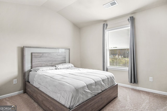 bedroom with carpet flooring and lofted ceiling