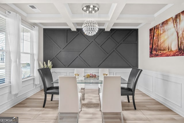 dining room with a chandelier, beam ceiling, plenty of natural light, and ornamental molding