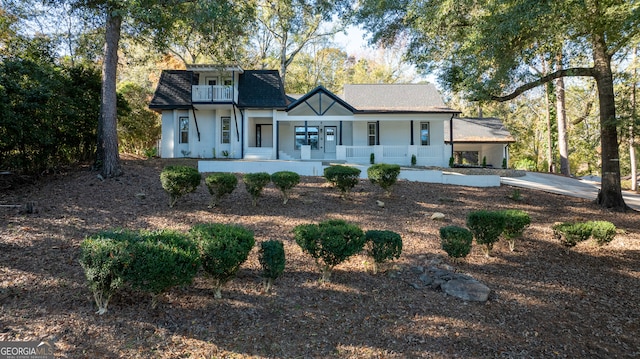 view of front of house featuring a porch and a balcony