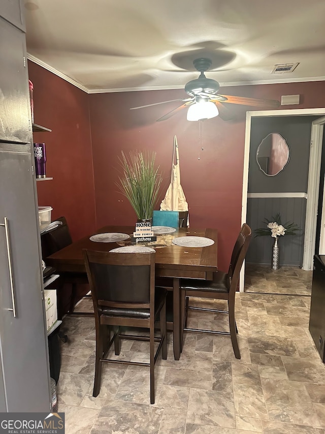 dining room with ceiling fan and crown molding