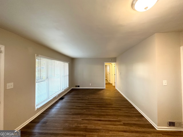 empty room with dark hardwood / wood-style floors