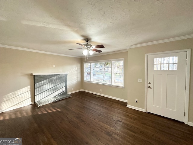 foyer featuring dark hardwood / wood-style floors, ceiling fan, crown molding, and a textured ceiling