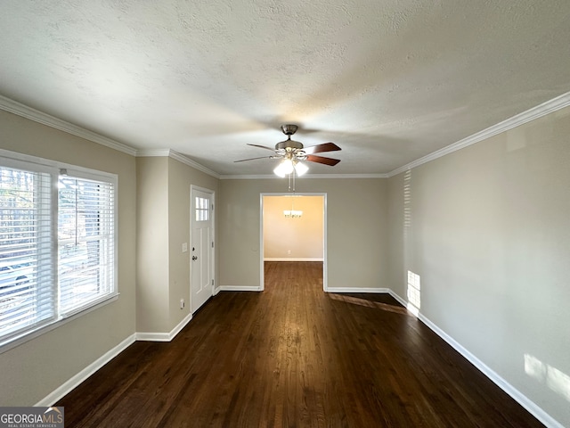 interior space with ceiling fan, dark hardwood / wood-style flooring, ornamental molding, and a textured ceiling