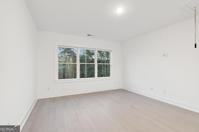 unfurnished room with light wood-type flooring