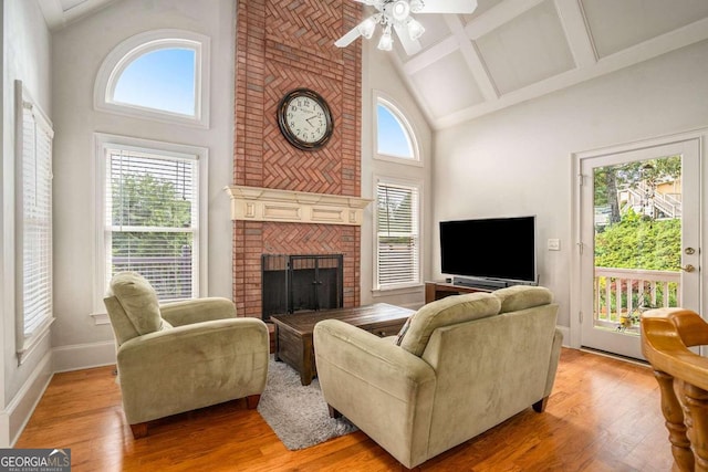 living room featuring ceiling fan, light hardwood / wood-style floors, and high vaulted ceiling