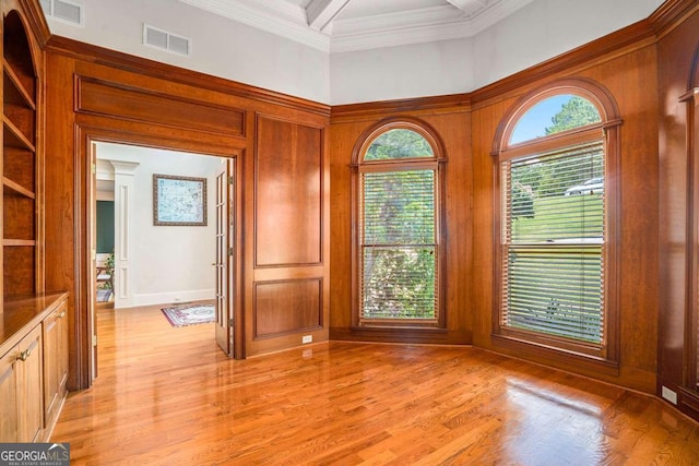 unfurnished room featuring crown molding and light hardwood / wood-style floors