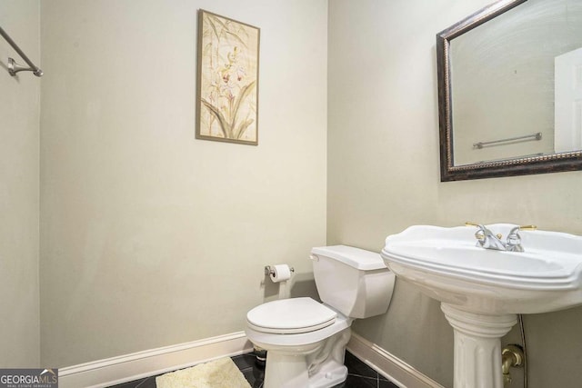 bathroom with tile patterned flooring and toilet