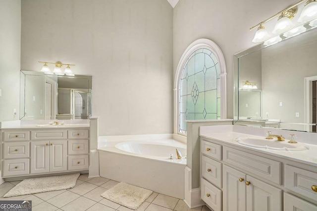 bathroom featuring tile patterned flooring, vanity, and plus walk in shower