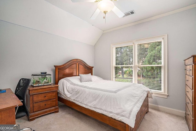 carpeted bedroom featuring ornamental molding, multiple windows, lofted ceiling, and ceiling fan