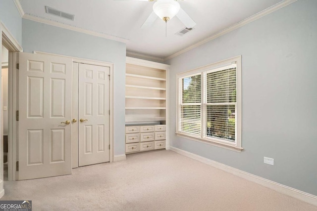 unfurnished bedroom featuring ceiling fan, light colored carpet, and ornamental molding