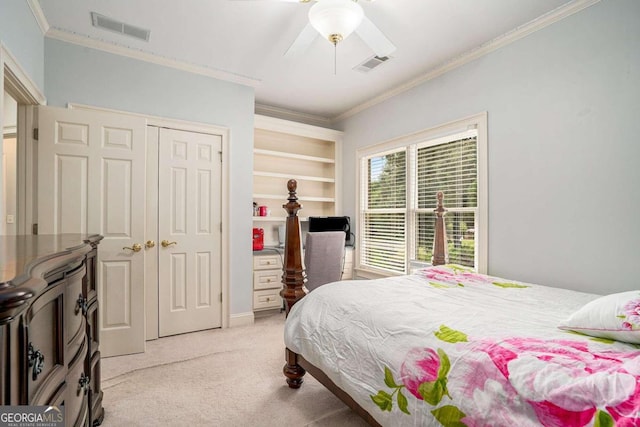 bedroom featuring ceiling fan, a closet, light colored carpet, and ornamental molding