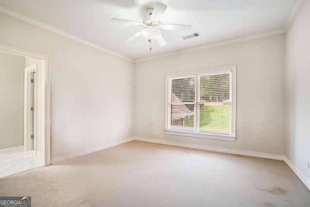 empty room with ceiling fan, carpet floors, and ornamental molding