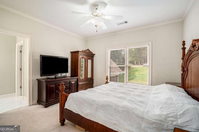 carpeted bedroom with ceiling fan and ornamental molding