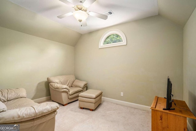 sitting room featuring ceiling fan, light colored carpet, and vaulted ceiling