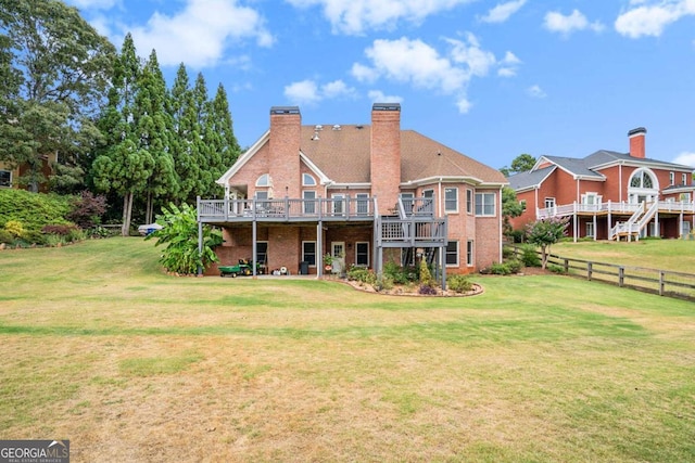 back of property featuring a yard and a deck