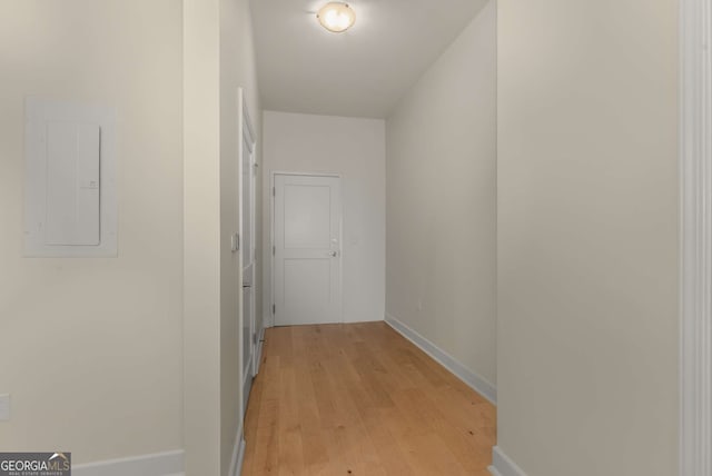 corridor featuring electric panel and light hardwood / wood-style floors