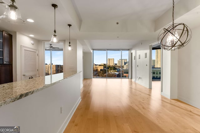 hallway with light hardwood / wood-style floors