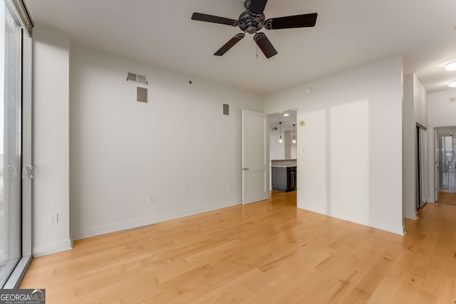 empty room featuring light hardwood / wood-style flooring and ceiling fan