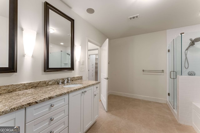 bathroom with vanity, tile patterned floors, and walk in shower