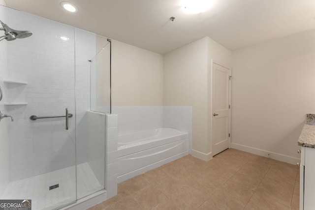 bathroom with tile patterned floors, vanity, and separate shower and tub